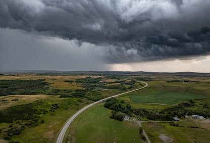A large black cloud over top of an Alberta prairie.